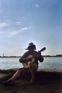 Max playing his own songs on his guitar (he wrote a song with one verse for every guy he learned on his trip)